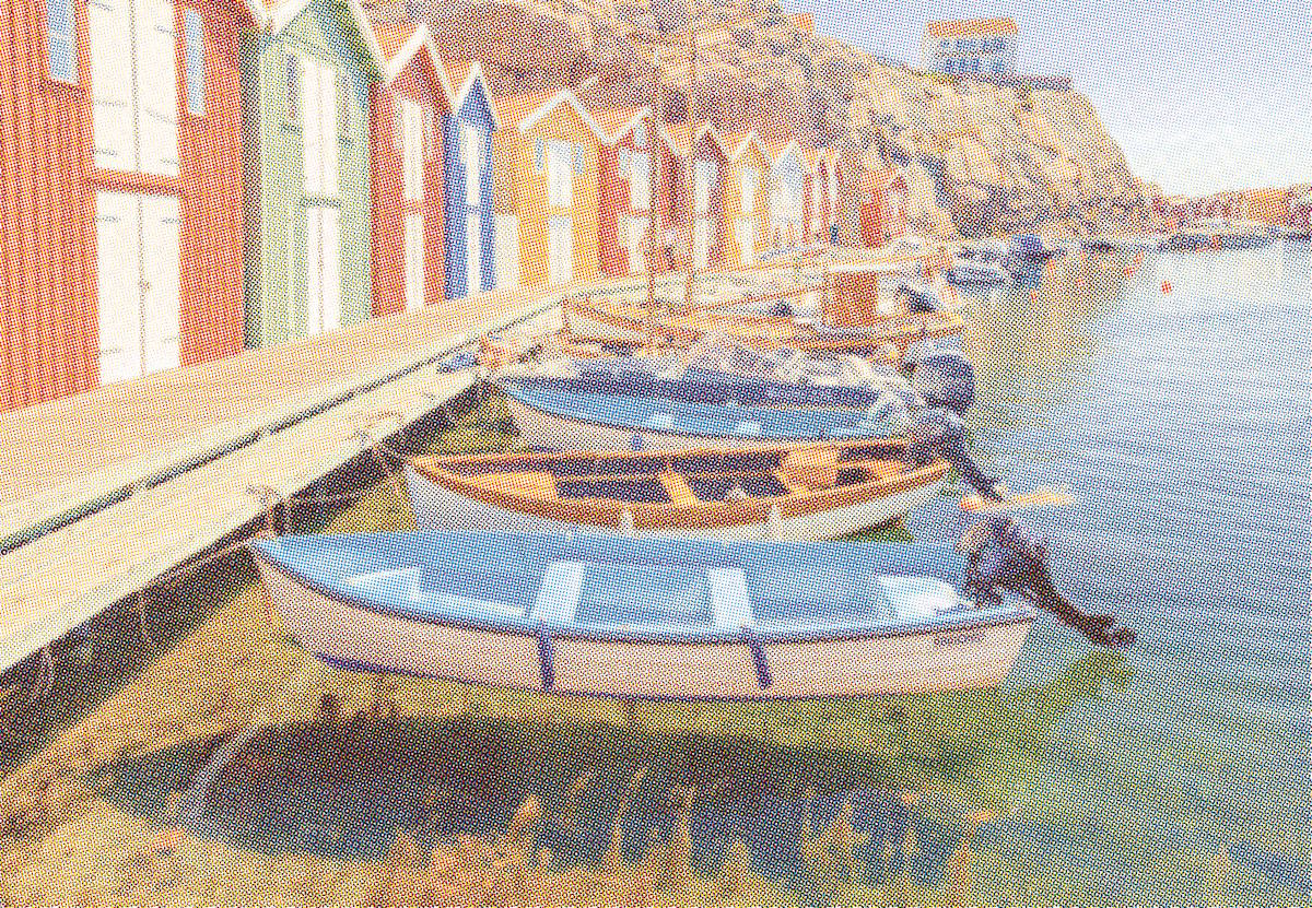Row of colourful boat sheds and moored rowing boats rendered as a full-colour newspaper halftone screen